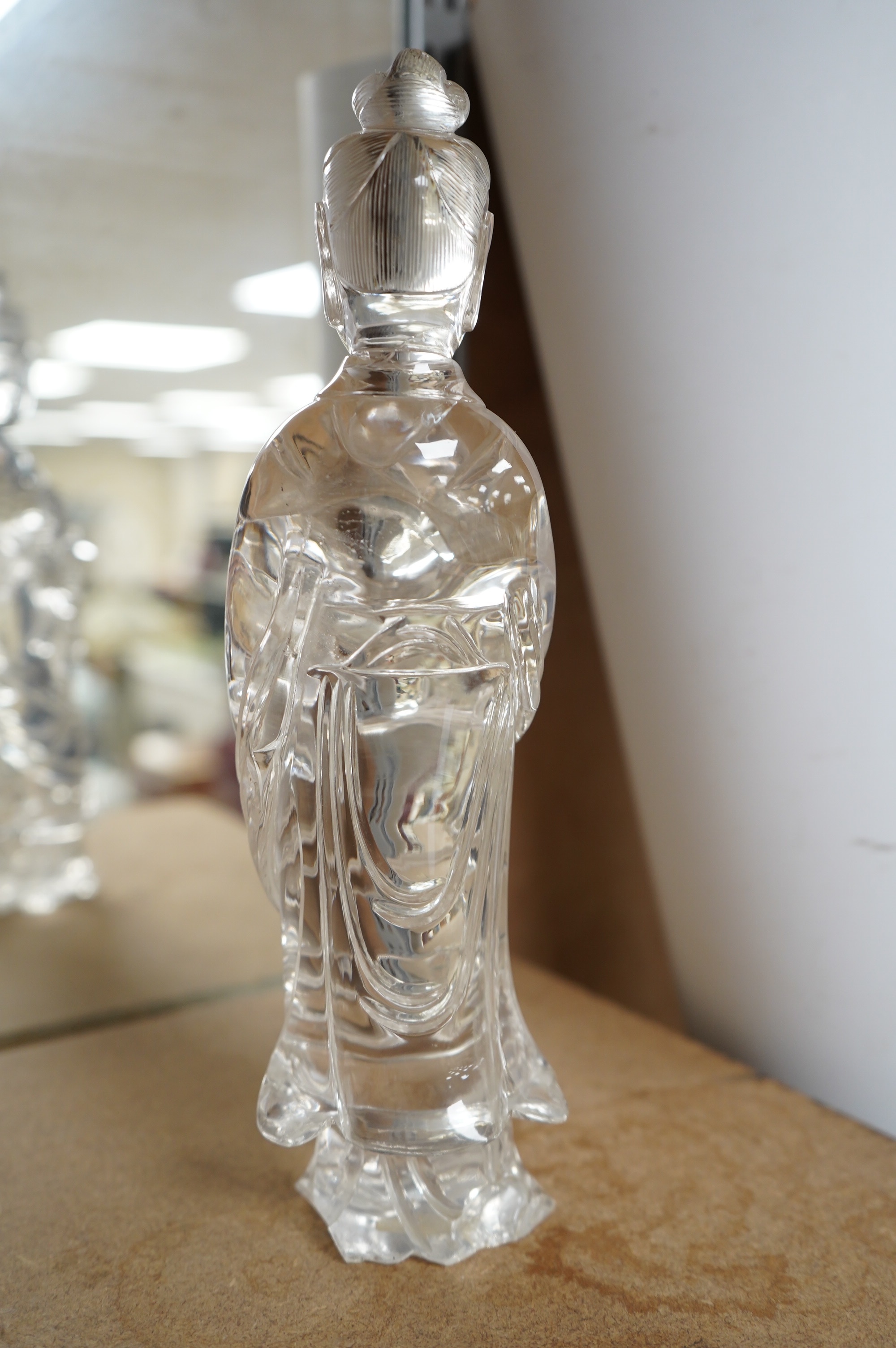 A large Chinese rock crystal figure of a standing lady holding a peony branch, 20th century, 27cm high. Condition - some chips to base